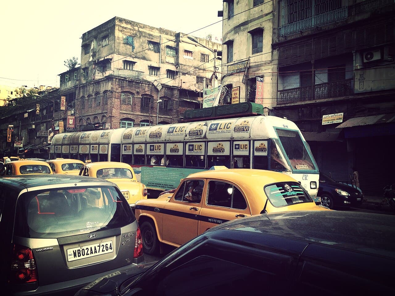 A yellow tram rolling through Kolkata